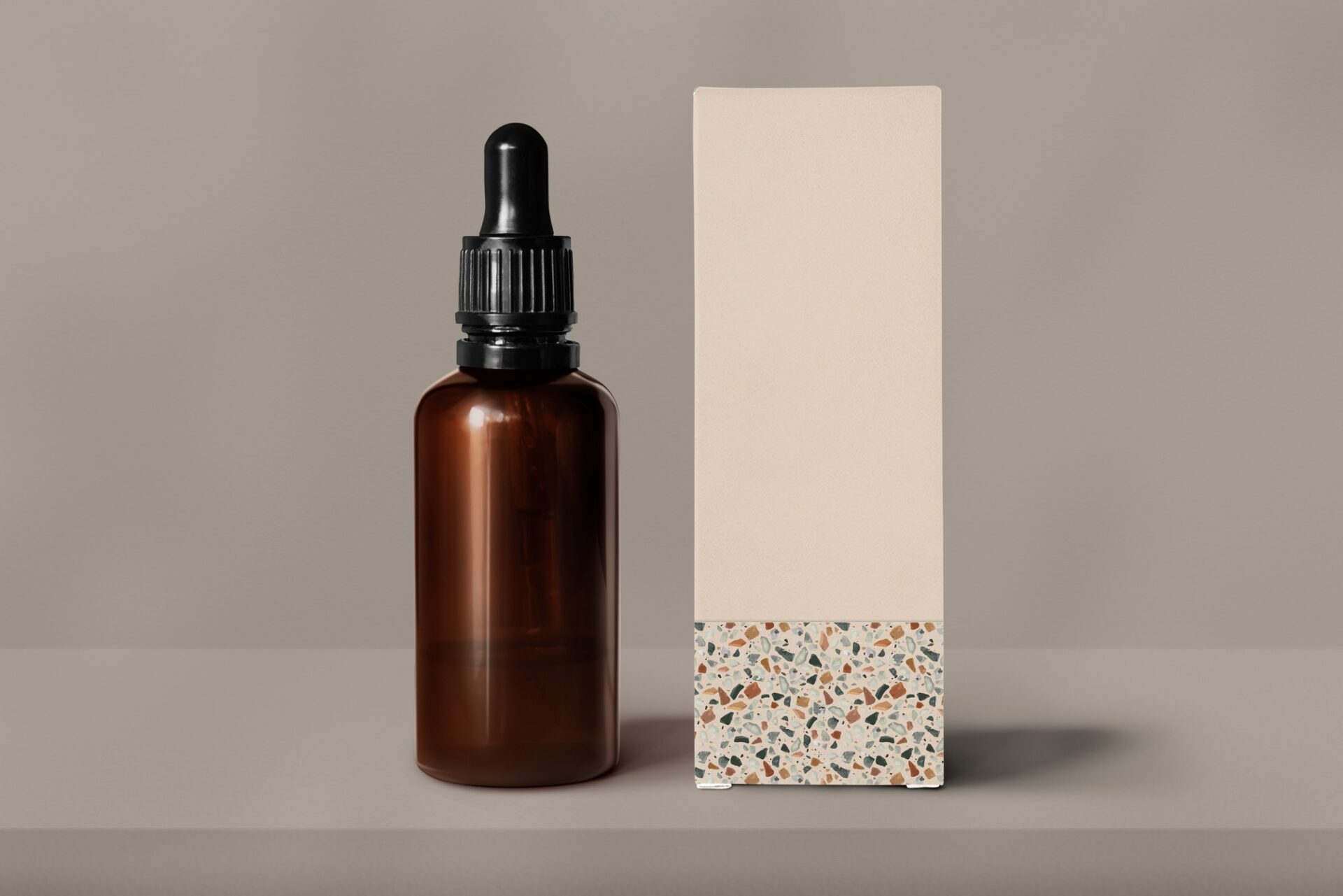 Brown glass dropper bottle, beige paper box, beauty product packaging