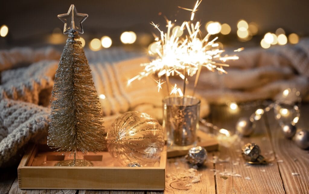 Cozy Christmas background with glowing sparklers and decor details.